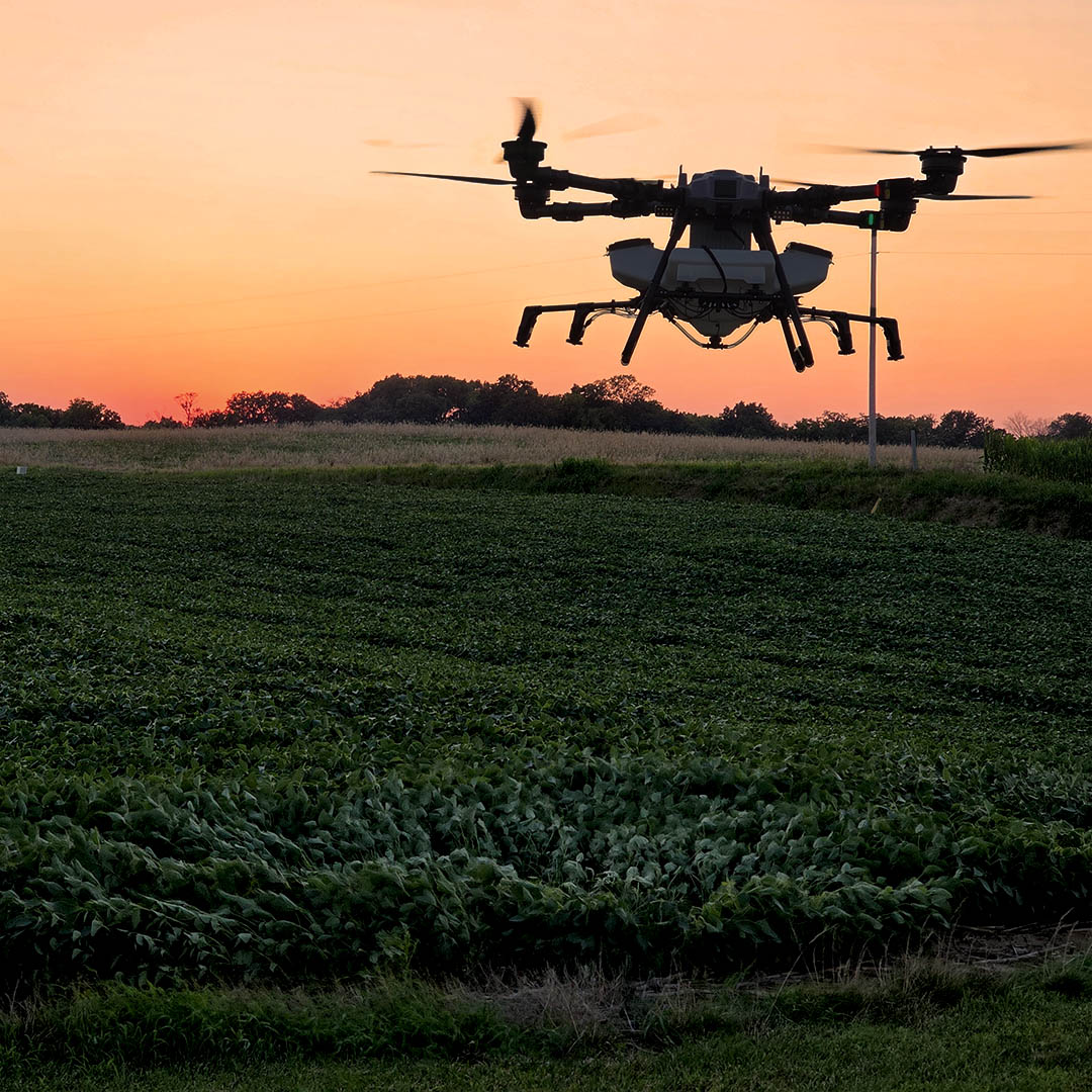 Elevon Aerial Ag Z80 spray drone flying by crops at sunset